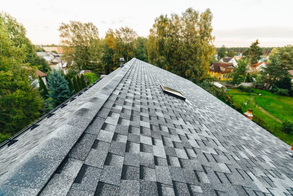 Beautiful new asphalt shingle roof with greenery in the background in Arthur Kill Rd, Staten Island, NY 10306, USA